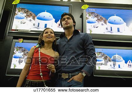 Couple at TV showroom View Large Photo Image Stock Photography - Couple at TV showroom. Fotosearch