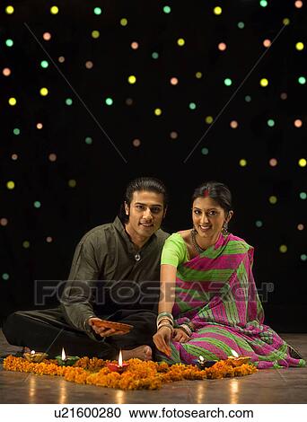 Couple celebrating Diwali View Large Photo Image Stock Image - Couple celebrating Diwali. Fotosearch