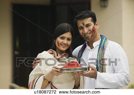 Stock Image - Couple celebrating Holi Festival . Fotosearch