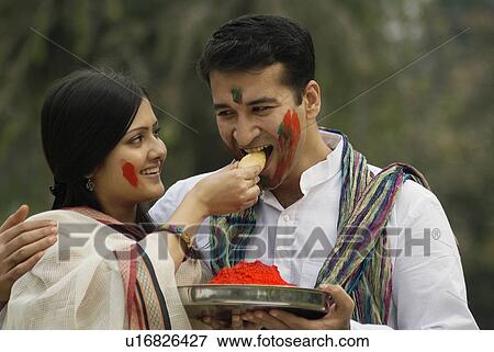 Stock Photo - Couple celebrating holi. Fotosearch