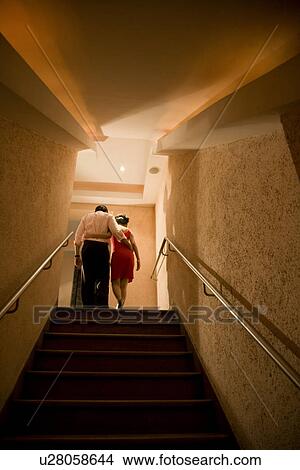 Couple climbing up the stairs View Large Photo Image Picture - Couple climbing up the stairs. Fotosearch
