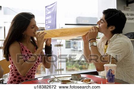 Couple eating dosa View Large Photo Image Stock Image - Couple eating dosa. Fotosearch