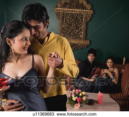 Couple enjoying a drink View Large Photo Image Stock Image - Couple enjoying a drink. Fotosearch