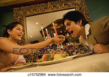 Couple enjoying a meal View Large Photo Image Picture - Couple enjoying a meal. Fotosearch