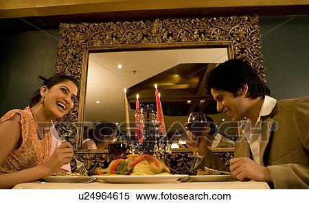Stock Photography - Couple enjoying a meal. Fotosearch