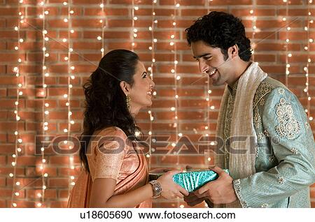 Couple exchanging gifts View Large Photo Image Stock Image - Couple exchanging gifts. Fotosearch