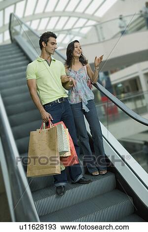 Couple on escalator View Large Photo Image Stock Image - Couple on escalator. Fotosearch