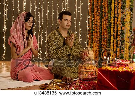 Stock Photography - Couple performing a pooja. Fotosearch