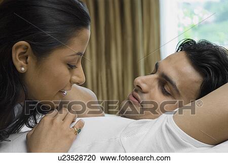 Stock Image - Couple sharing a light moment. Fotosearch