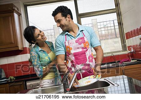 Stock Photography - Couple washing dishes in the kitchen. Fotosearch