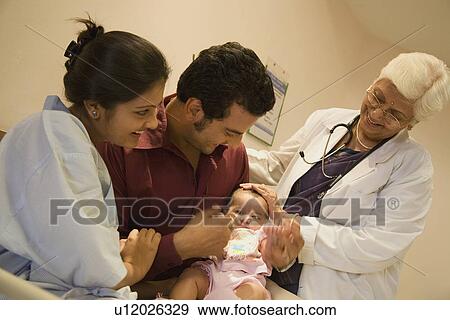 Stock Photo - Couple with their child. Fotosearch