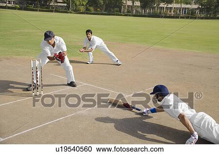 Stock Image - Cricketers in action. Fotosearch
