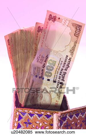 Stock Photography - Currency notes sticking out of holder. Fotosearch
