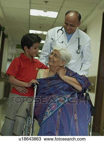 Stock Image - Doctor and a family. Fotosearch
