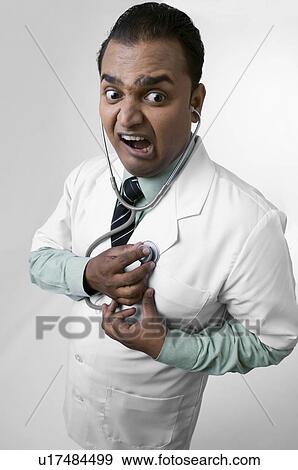 Stock Photo - Doctor checking his heartbeat. Fotosearch