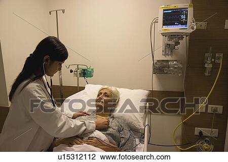 Doctor checking patient's heartbeat View Large Photo Image Stock Image - Doctor checking patient's heartbeat. Fotosearch