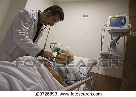 Doctor checking patient's heartbeat View Large Photo Image Stock Image - Doctor checking patient's heartbeat. Fotosearch