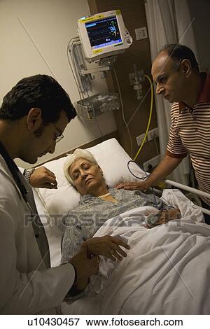 Doctor checking patient's pulse View Large Photo Image Stock Photo - Doctor checking patient's pulse. Fotosearch