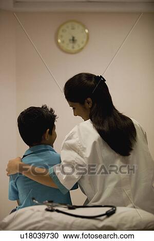 Doctor comforting her patient View Large Photo Image Stock Image - Doctor comforting her patient. Fotosearch