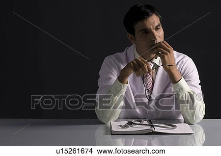 Doctor contemplating View Large Photo Image Picture - Doctor contemplating. Fotosearch