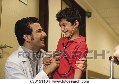 Picture - Doctor having fun with his patient. Fotosearch
