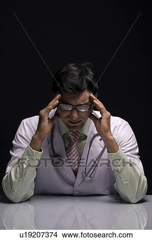 Picture - Doctor in deep thought. Fotosearch
