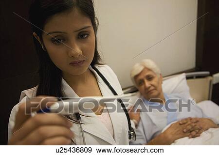 Stock Photo - Doctor taking patient's temperature. Fotosearch