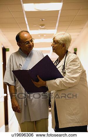 Stock Photograph - Doctor talking to her patient. Fotosearch