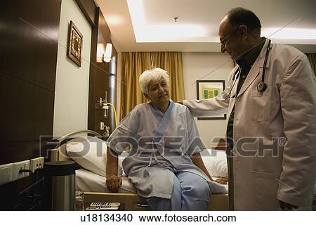 Stock Image - Doctor with his patient. Fotosearch