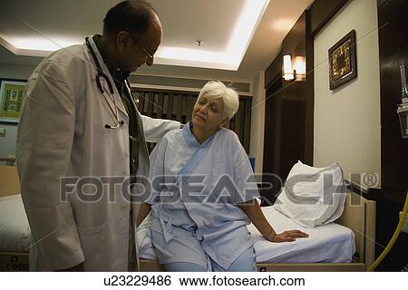 Stock Photograph - Doctor with his patient. Fotosearch