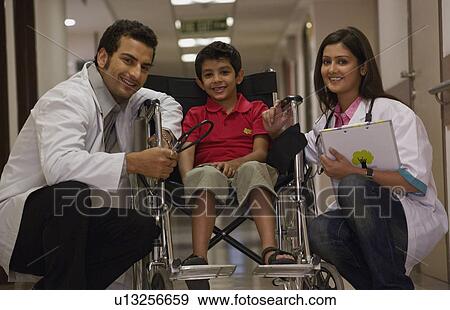 Doctors and a child View Large Photo Image Stock Photo - Doctors and a child. Fotosearch