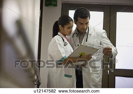 Stock Image - Doctors discussing work. Fotosearch