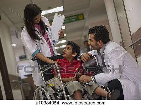 Picture - Doctors talking to a boy. Fotosearch