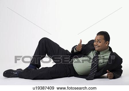 Stock Photo - Executive giving thumbs up. Fotosearch