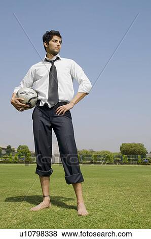 Executive holding a football View Large Photo Image Stock Photo - Executive holding a football. Fotosearch