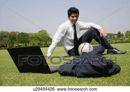 Stock Photograph - Executive in a football ground. Fotosearch