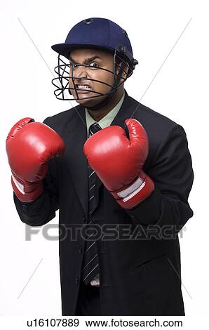 Executive in a helmet and boxing gloves View Large Photo Image Stock Photo - Executive in a helmet and boxing gloves. Fotosearch