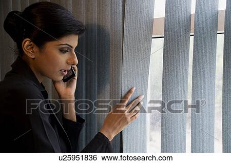 Stock Photograph - Executive looking out the window. Fotosearch
