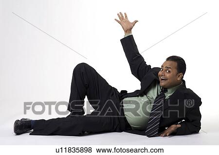 Stock Photo - Executive raises a hand. Fotosearch