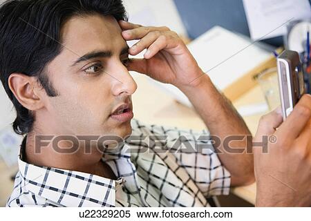 Stock Photography - Executive reading an SMS. Fotosearch