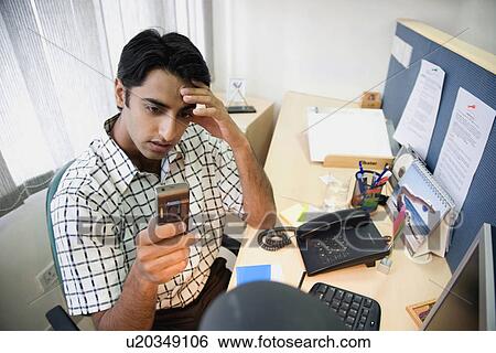 Executive reading SMS View Large Photo Image Stock Photograph - Executive reading SMS. Fotosearch