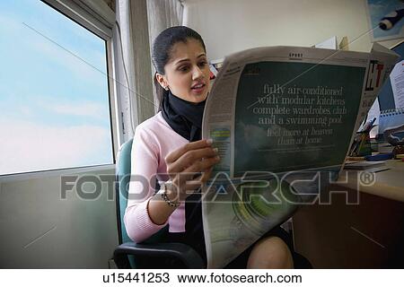 Stock Image - Executive reading the newspaper. Fotosearch