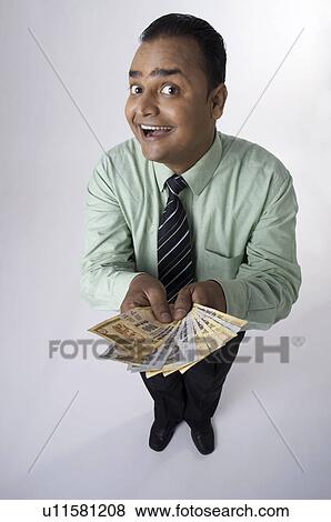 Stock Photo - Executive shows money. Fotosearch
