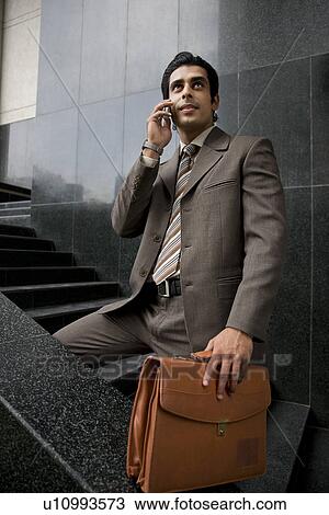 Executive talking on his phone View Large Photo Image Stock Image - Executive talking on his phone. Fotosearch