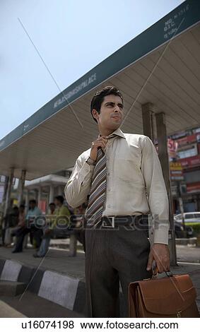 Executive waiting at the bus stop View Large Photo Image Stock Photo - Executive waiting at the bus stop. Fotosearch