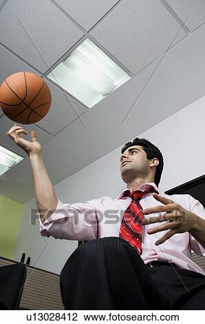 Stock Image - Executive with a basketball. Fotosearch