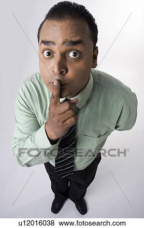 Stock Photo - Executive with finger on the lips. Fotosearch