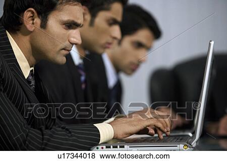 Executive working on a laptop View Large Photo Image Stock Photo - Executive working on a laptop. Fotosearch