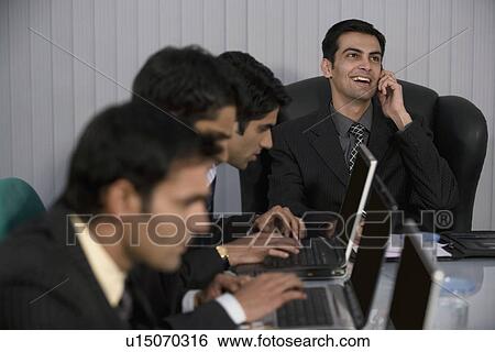 Executive working on a laptop View Large Photo Image Stock Photograph - Executive working on a laptop. Fotosearch