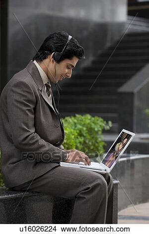 Picture - Executive working on his laptop. Fotosearch